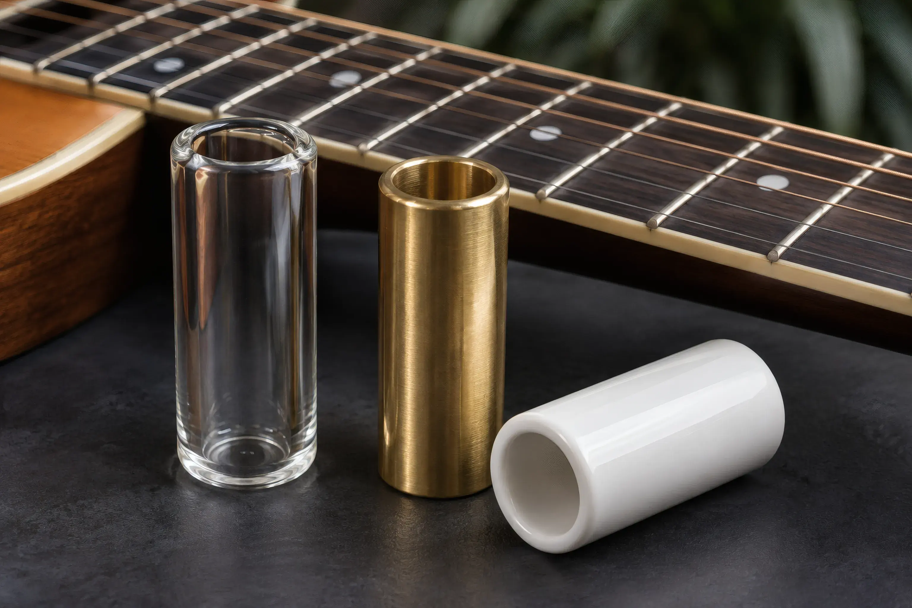 Glass, brass and ceramic guitar slides compared side by side