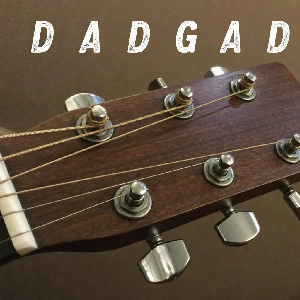 Acoustic guitar headstock labeled D A D G A D from the lowest string to the highest